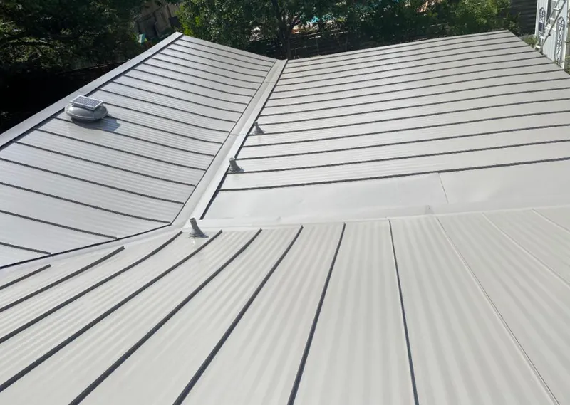 Solar attic fan installed on a metal roof for Roof Ventilation in Boone